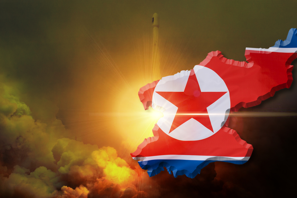 North Korea map with flag over rocket launch background