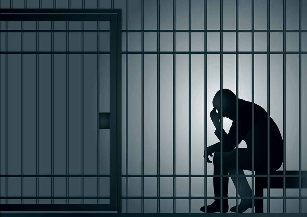 1349712146 featured image Silhouette of person sitting in a jail cell
