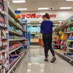 Person shopping in a CVS pharmacy aisle