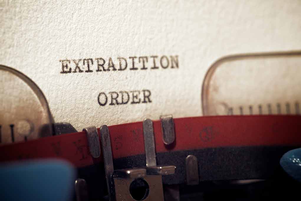 Typewriter typing extradition order document page closeup