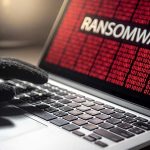 App Breach EXPOSES Thousands—Nobody Noticed Gloved hand on laptop with ransomware screen