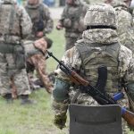 Military Buffer Zone EXPANDED – TWO New Zones Soldiers in camouflage gear gathered on grass field