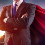 Businessman wearing a cape standing confidently