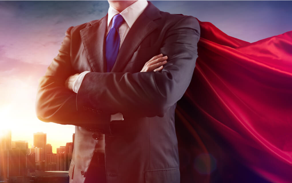 Businessman wearing a cape standing confidently