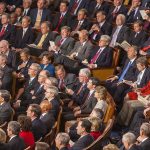 Trump SLAMS Spain at NATO — Tariffs Coming Audience of officials sitting and reading documents in auditorium