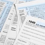 Tax forms and documents overlapping on surface