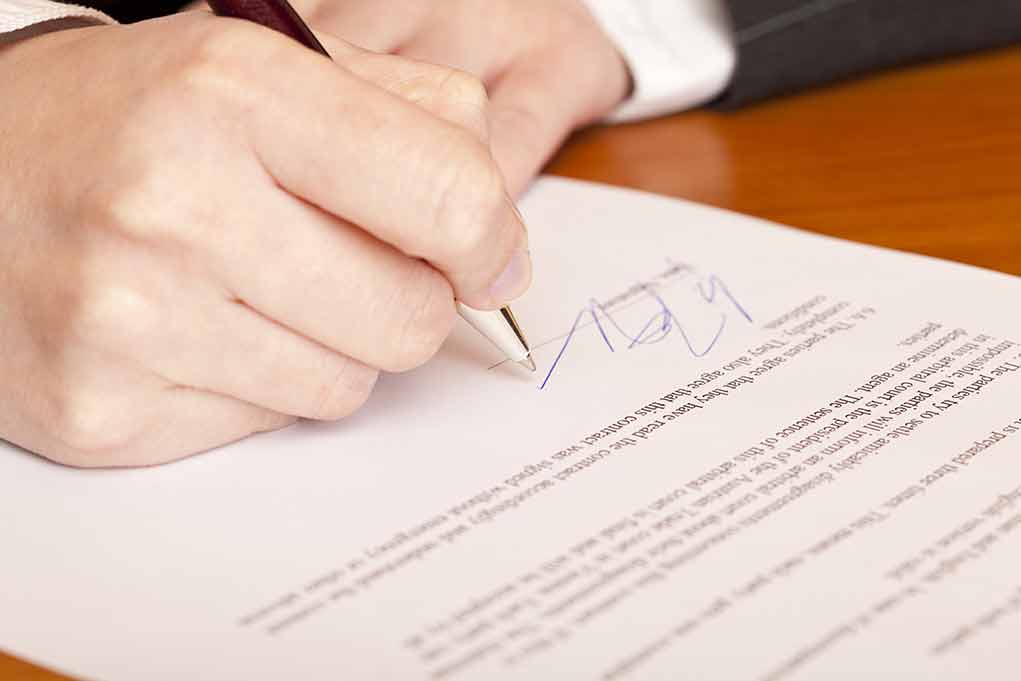 66092728 featured image Hand signing a document with a pen