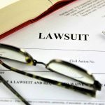 Lawsuit document with glasses pen and book