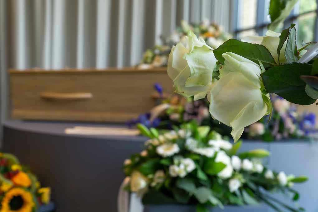 1518299909 White roses in front of a casket