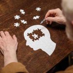 Revolutionary Autism Study Flips Old Views Elderly person completing head-shaped jigsaw puzzle