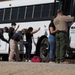 Border Numbers PLUMMET—The Numbers Don’t Lie Border patrol officers investigating people near a bus