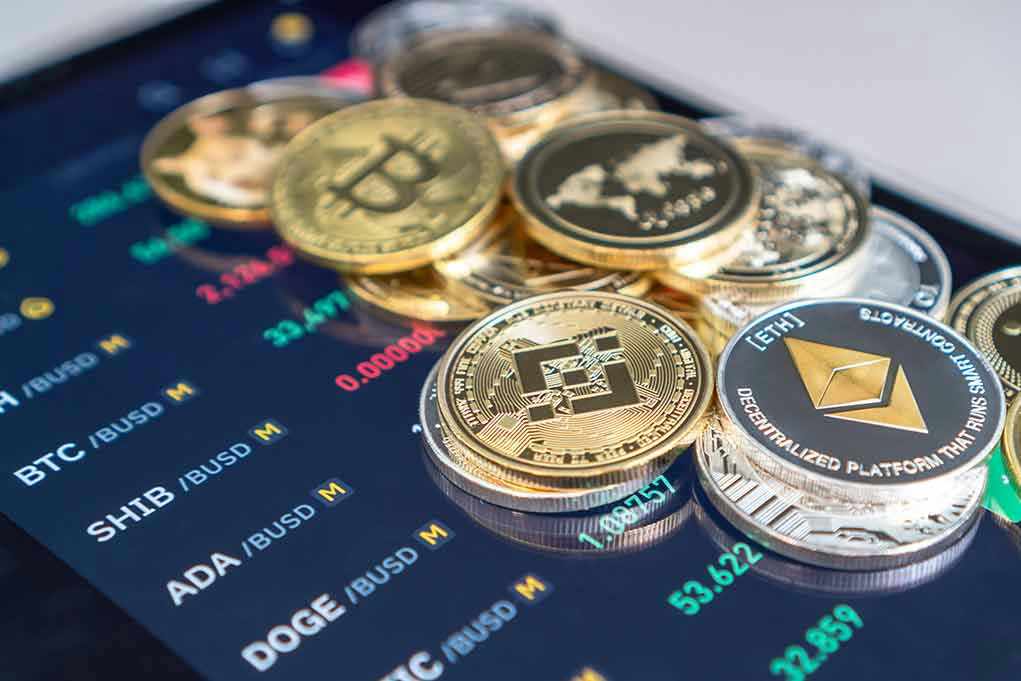 Cryptocurrency coins on a trading screen background