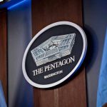 Pentagon Walkout STUNS Aspen Security Forum The Pentagon emblem between two flags