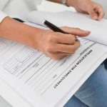 Job Market SHOCK — First Decline in 2 Years Person filling out job application form