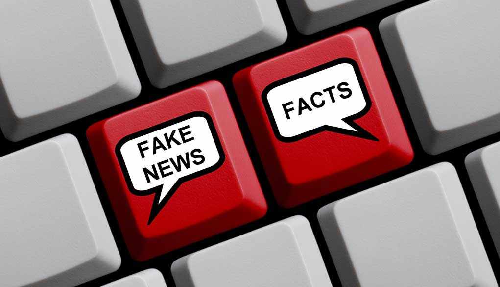 Keyboard keys labeled "Fake News" and "Facts."