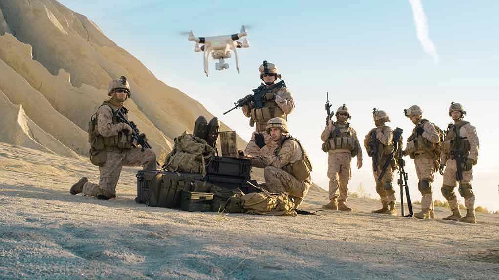 676000819 Soldiers operating a drone in a desert environment