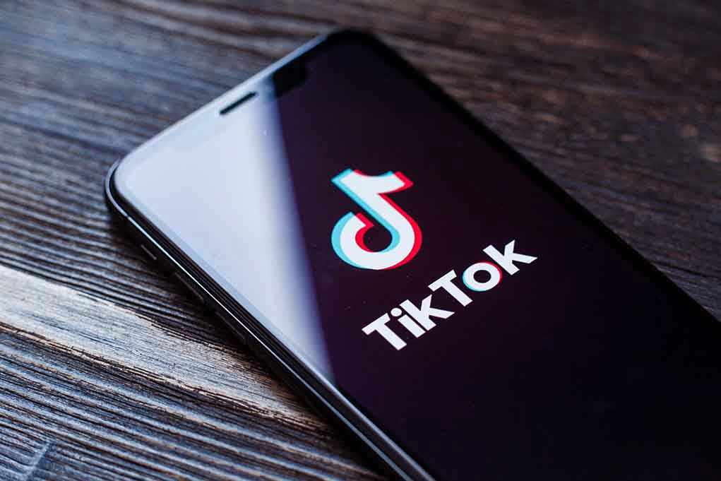 1455492983 Phone screen showing TikTok logo and app.