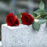 Red roses on a gray stone surface