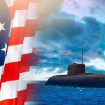 American flag and submarine at sea under a cloudy sky