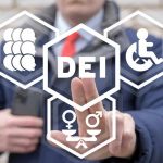 Person pointing at DEI symbols on glass