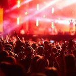 Gang Mayhem Erupts—NYPD Clueless as Killers Vanish Crowd at concert with vibrant stage lights.