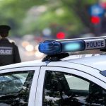 Police car and officer on a city street
