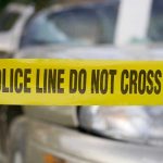 Gunman’s Chilling Message Raises National Alarm Yellow police tape in front of a car.