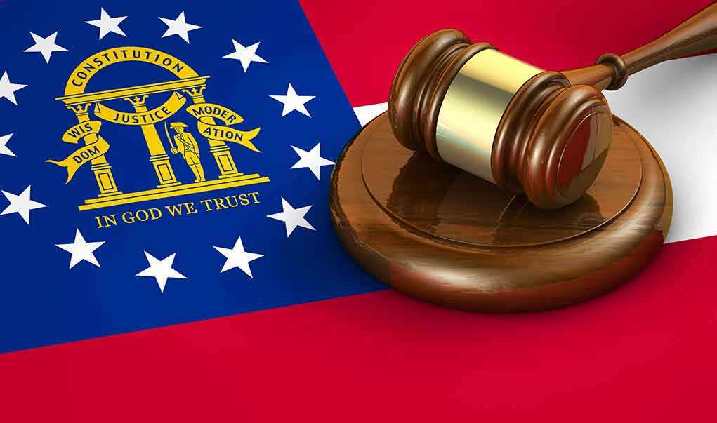 349481612 Georgia flag and judge's gavel on wooden base.