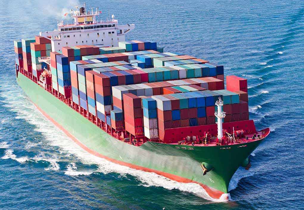 shutterstock_230506738.jpg A large cargo ship loaded with colorful containers sailing on the ocean