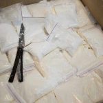 $569 Million Meth Operation BLOCKED—China in the Crosshairs Bags of white powder with scissors in cardboard box.
