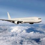 Airline Crews Getting NFL-Type BRAIN DAMAGE A white airplane flying above fluffy clouds in a blue sky