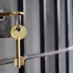 Bolton Facing Lengthy Prison Sentence Key in lock of prison cell door.