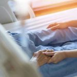 Decomposed Body Found — Eldercare Facility Under Fire Hospital patient holding visitors hand reassuringly.