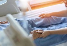 Decomposed Body Found — Eldercare Facility Under Fire Hospital patient holding visitors hand reassuringly.