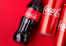 Trump Forces Coca-Cola’s SWEET Surrender Coca-Cola bottles and cans on red background.