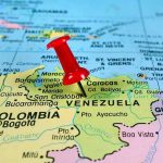 Venezuela Crisis — Maduro PUSHES BACK HARD! Red pin on Venezuela, South America map.