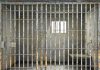 Shocking Verdict — Private Jail’s $42.75 Million Apology Empty rusty prison cell with a small window.