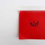 A red sticky note with the word 'No!' written in black ink