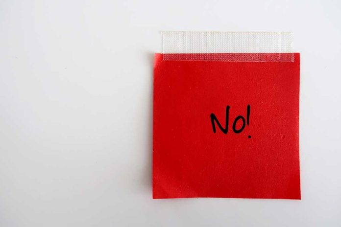 shutterstock_1536091325 (1).jpg A red sticky note with the word 'No!' written in black ink