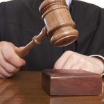 Judge BLOCKS Last-Ditch Plot Against Supreme Court A judge holding a gavel above a wooden block