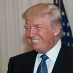 Trump’s Unprecedented Dual Sports Celebration A smiling man in formal attire with an American flag in the background