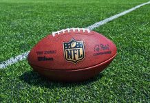 Beloved NFL ICON Shocking Arrest — WHAT HE DID! An NFL football resting on a green grass field