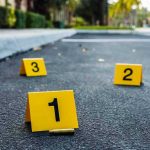 SHOCKING Murder-Suicide Rocks Major Air Base Crime scene markers on asphalt with bullet casing.