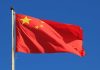 Trump’s Bold Move — China Left Powerless Chinese national flag waving against a clear blue sky