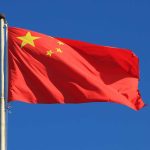 Trump’s Bold Move — China Left Powerless Chinese national flag waving against a clear blue sky