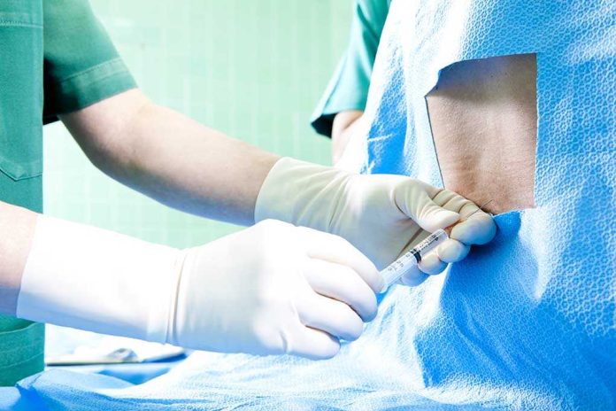 shutterstock_95481631.jpg Healthcare professional administering an injection to a patient in a surgical setting