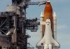 NASA Uncovers Solar System’s Fiery Secret Space shuttle on launch pad with support structure.