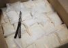 Drug Lord’s FAKE Death Exposed — Shocking Arrest Bags of white powder with scissors in cardboard box.