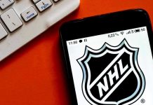 NHL Star’s SHOCKING $50K Scam Exposed NHL logo displayed on smartphone next to keyboard.