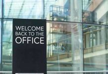 Welcome back to the office sign outside building.
